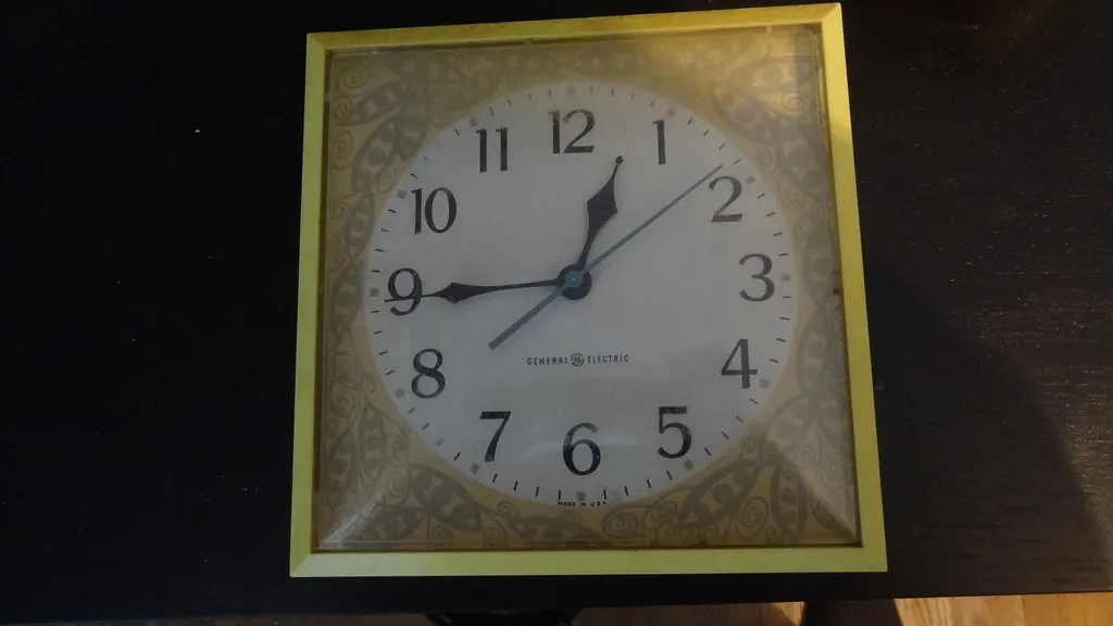 Clock on a kitchen wall marking a quiet break